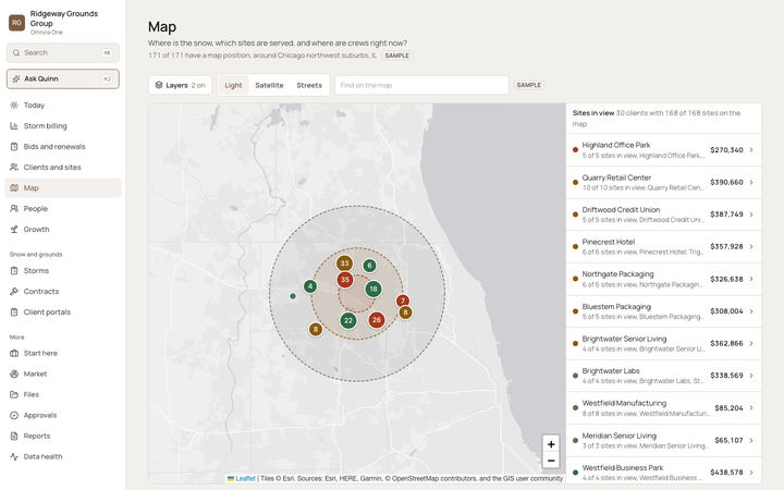 The Omnira One Map page for a sample snow and grounds company. Colored numbered circles group client sites inside dashed snowfall bands from the last storm. Buttons switch between light, satellite and streets maps, and a side list shows each client in view with its value.