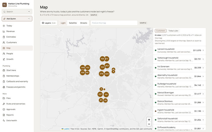 The Omnira One Map page for a sample plumbing company, around a large southern city. Numbered circles group customers across the northern suburbs and the city center. Buttons switch layers and between light, satellite and streets maps, and a side list shows the customers in view, with a tab for today's jobs.