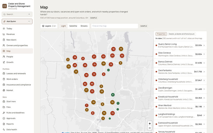 The Omnira One Map page for a sample property management company. Managed properties around Columbus, Ohio are grouped into numbered circles colored by status, with a layers control, Light, Satellite and Streets map buttons, and a side list of owners with dollar amounts beside a tab for deeds, probate and foreclosure.